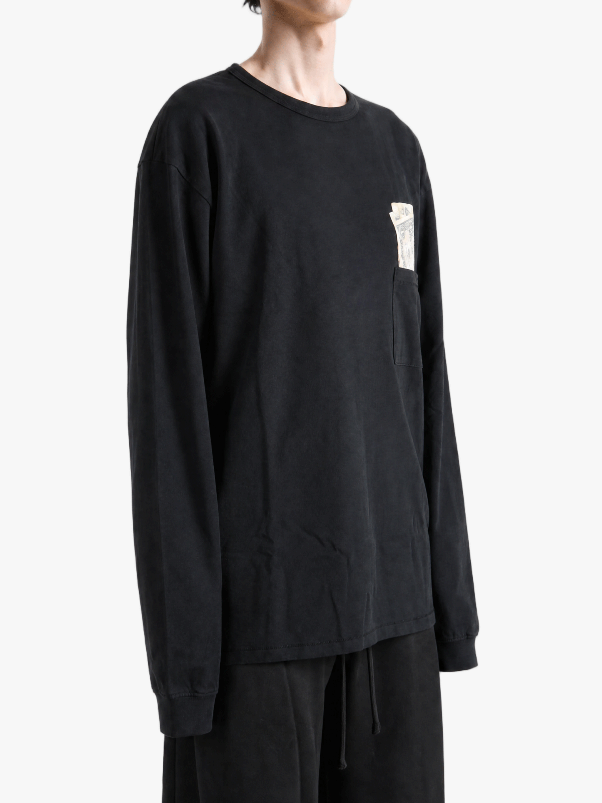 Black t-shirt worn by a person, showing the t-shirt fit