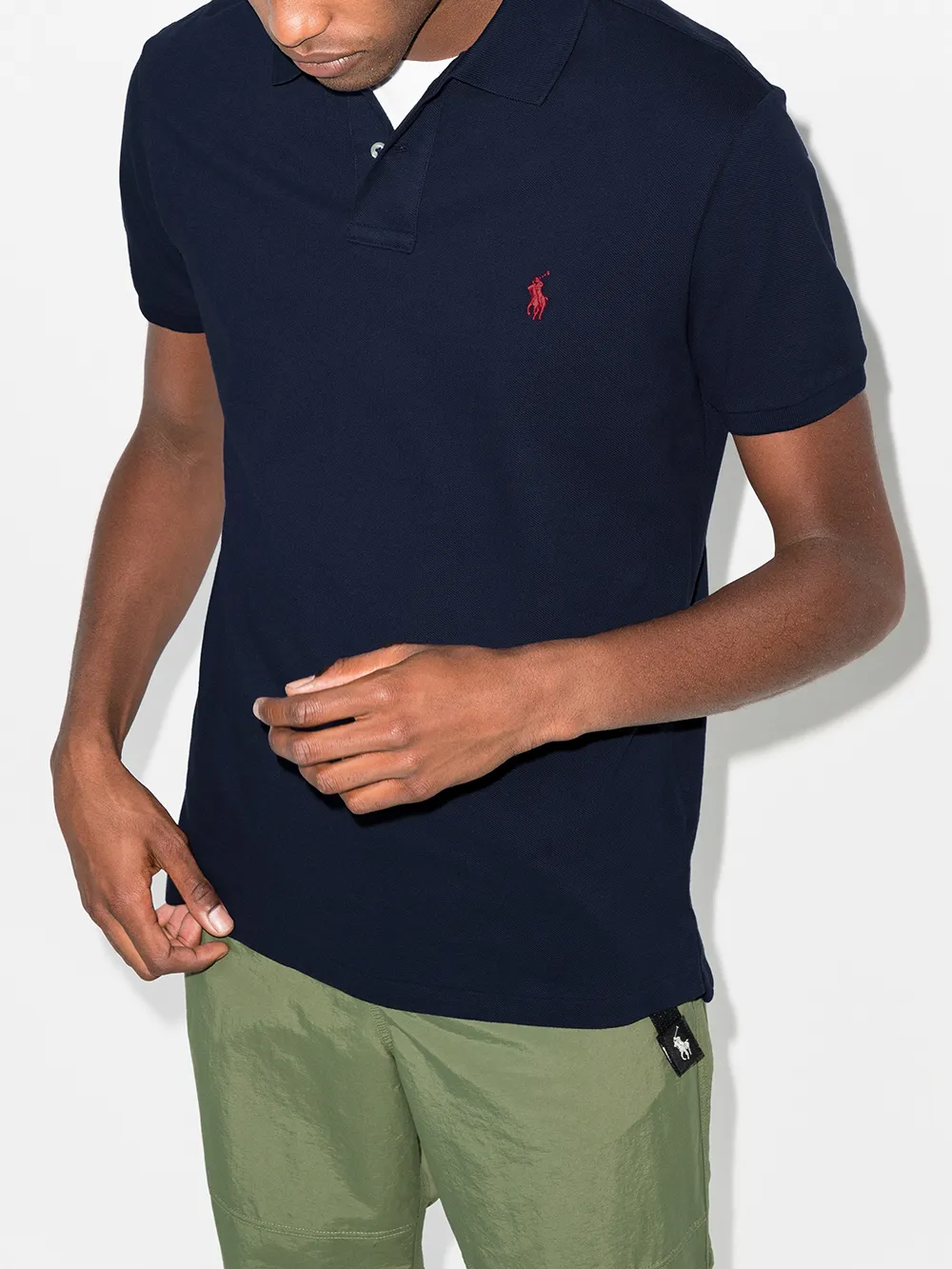 Navy shirts worn by a person, showing the shirt's fit