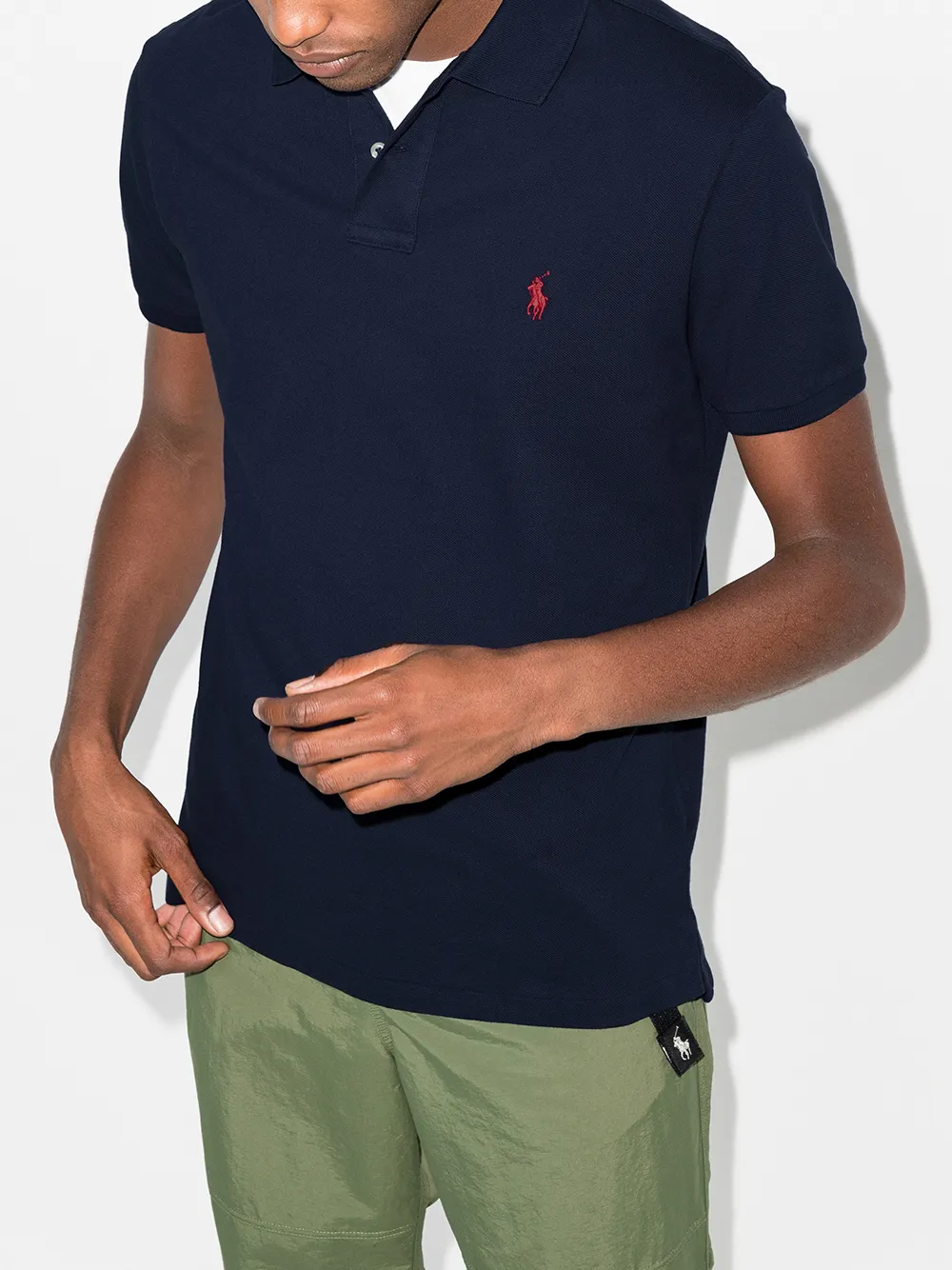 Navy shirts worn by a person, showing the shirt's fit