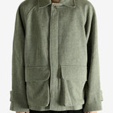 Green jacket worn by a person, showing the jacket fit