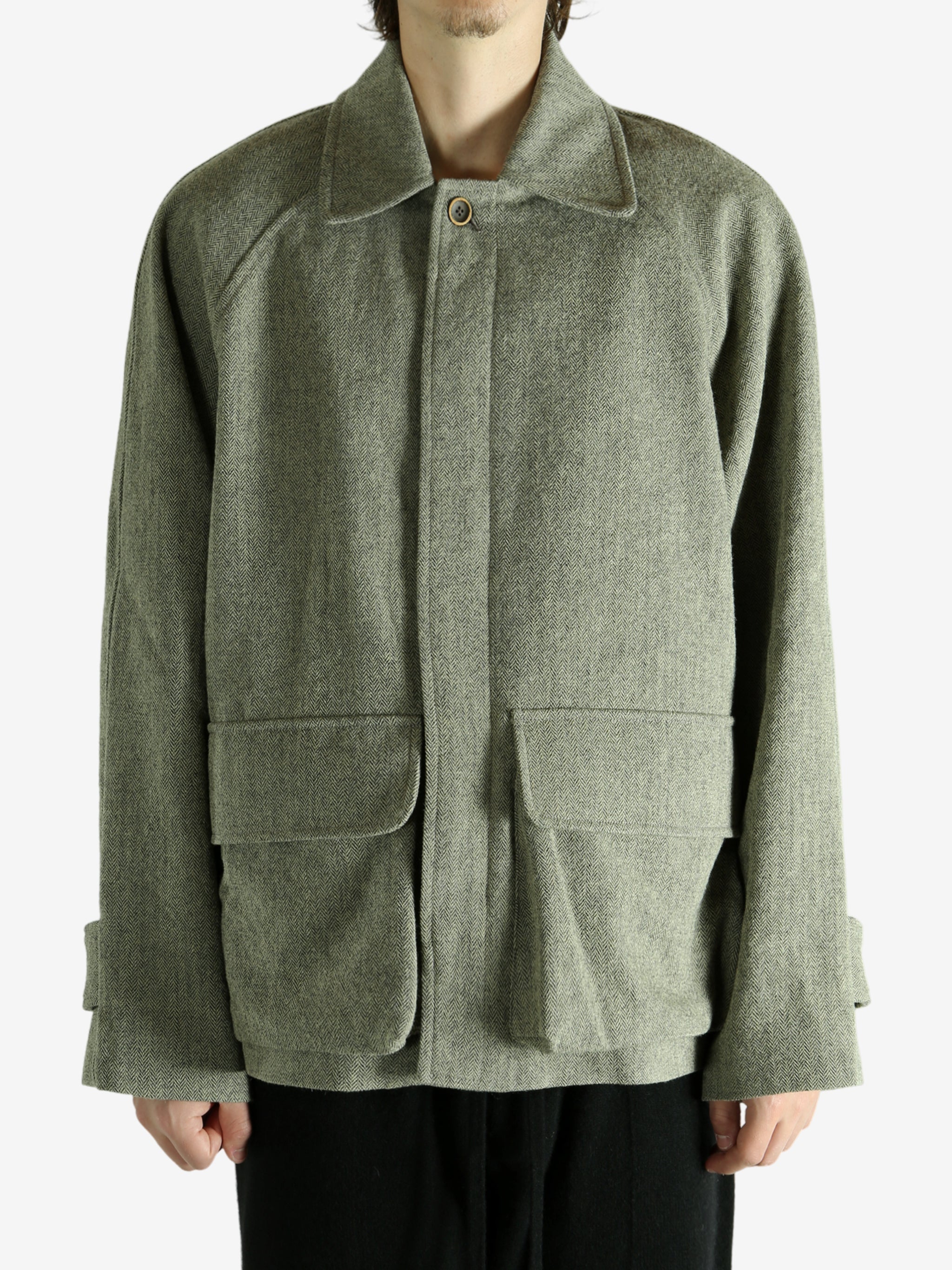 Green jacket worn by a person, showing the jacket fit