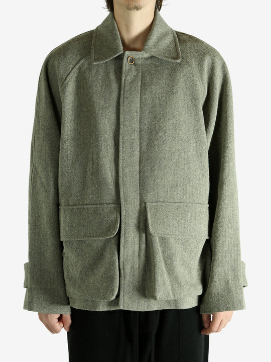 Green jacket worn by a person, showing the jacket fit