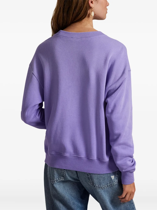 Purple sweatshirt worn by a person, showing the sweatshirt's fit
