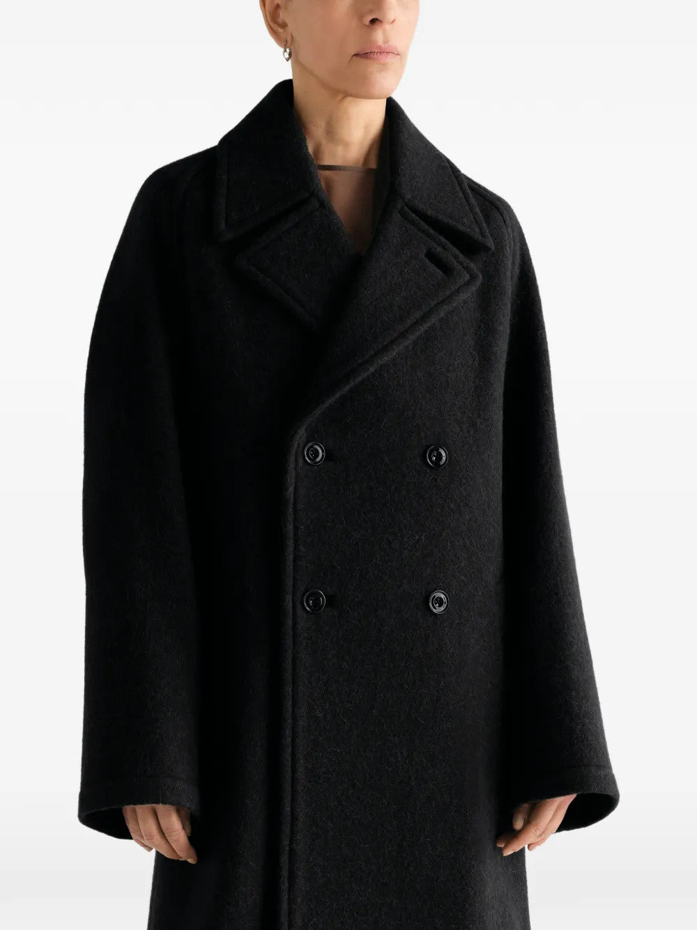 Black jacket worn by a person, showing the jacket fit