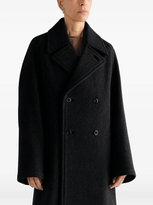 Black jacket worn by a person, showing the jacket fit