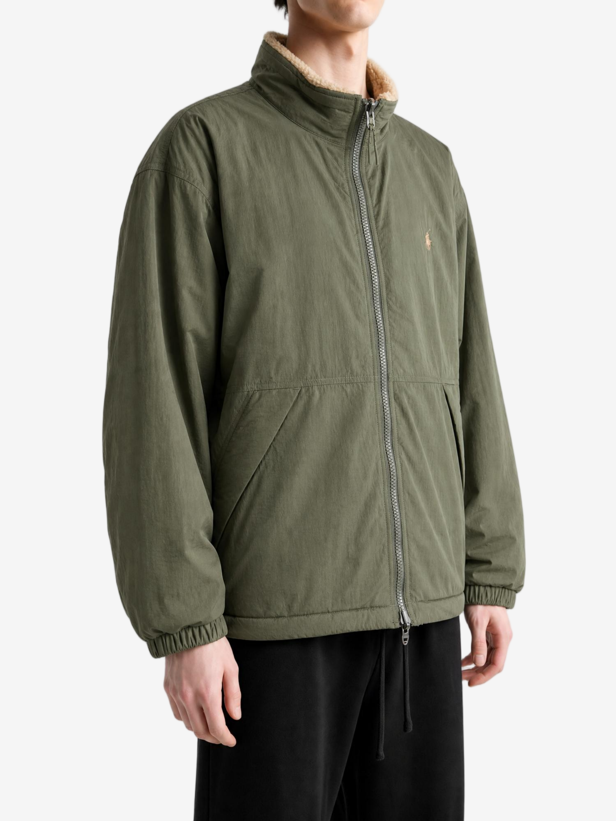 Green jacket worn by a person, showing the jacket fit
