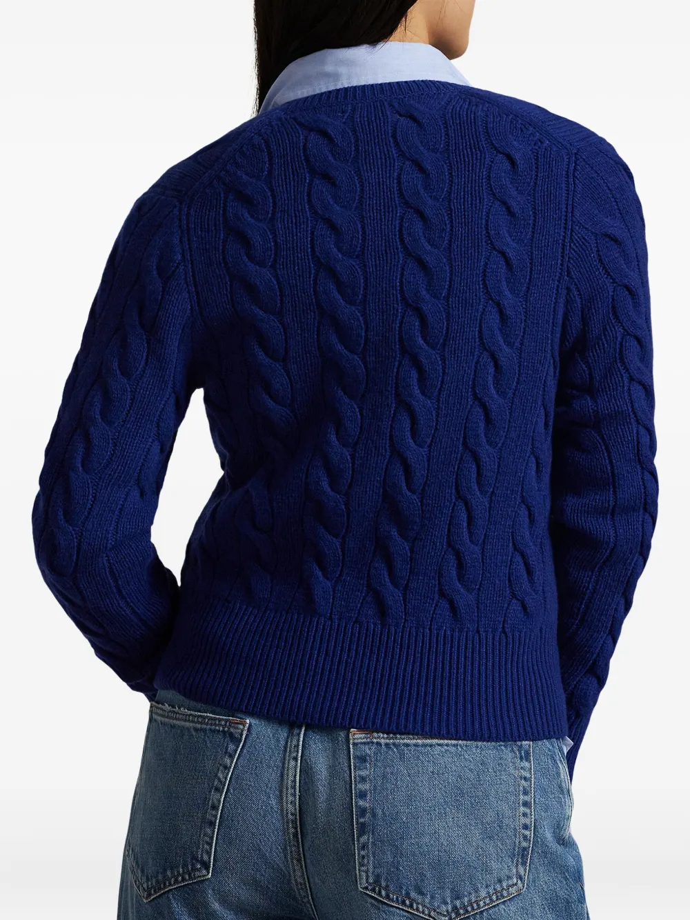 Blue sweater worn by a person, showing the sweater's fit