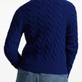 Blue sweater worn by a person, showing the sweater's fit