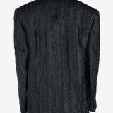 Black jacket worn by a person, showing the jacket's fit