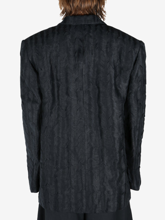 Black jacket worn by a person, showing the jacket's fit