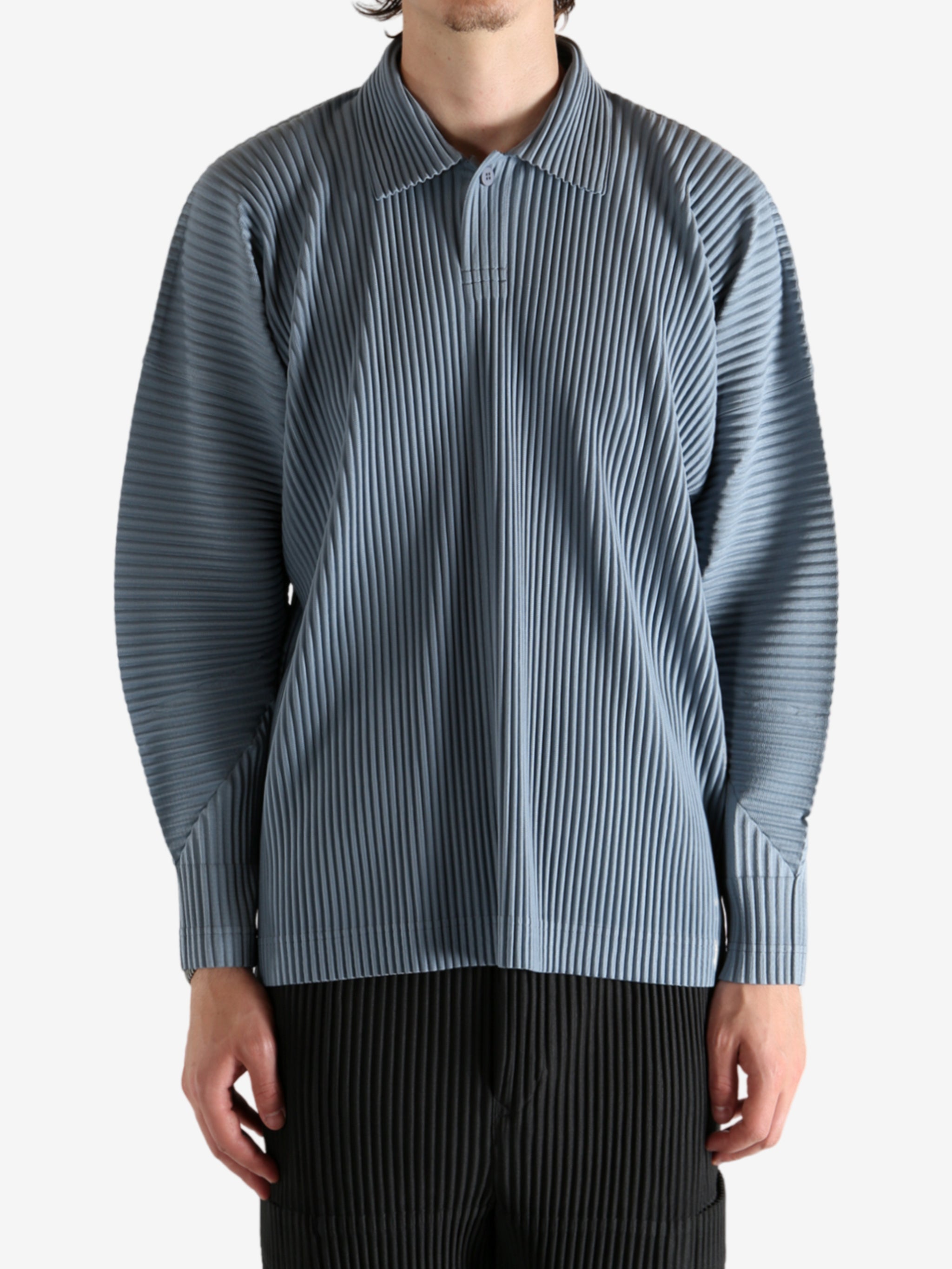 Blue shirts worn by a person, showing the shirt's fit