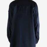 Navy shirt worn by a person, showing the shirt's fit