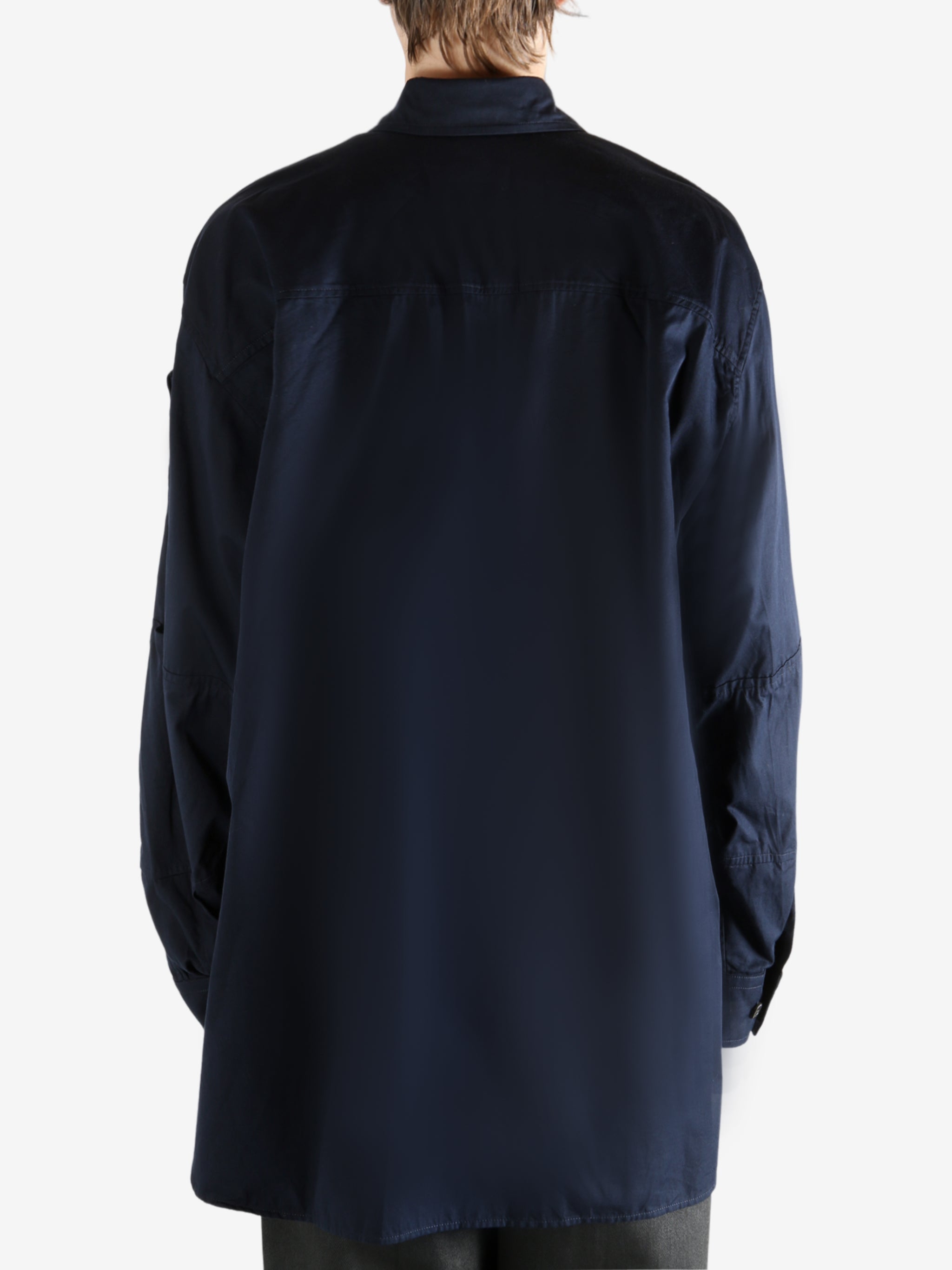 Navy shirt worn by a person, showing the shirt's fit