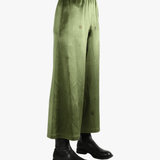 Green pants worn by a person, showing the pants fit