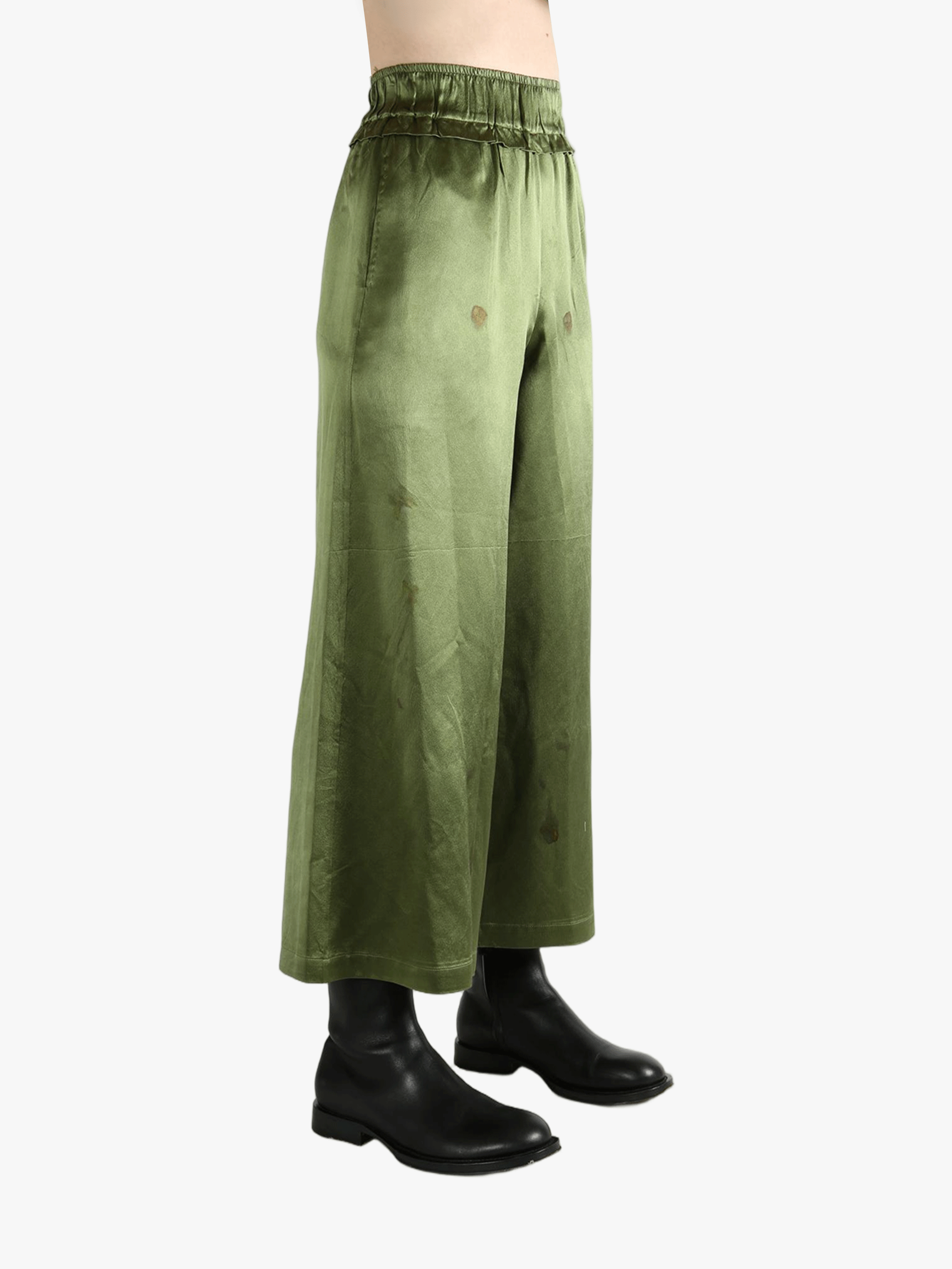 Green pants worn by a person, showing the pants fit