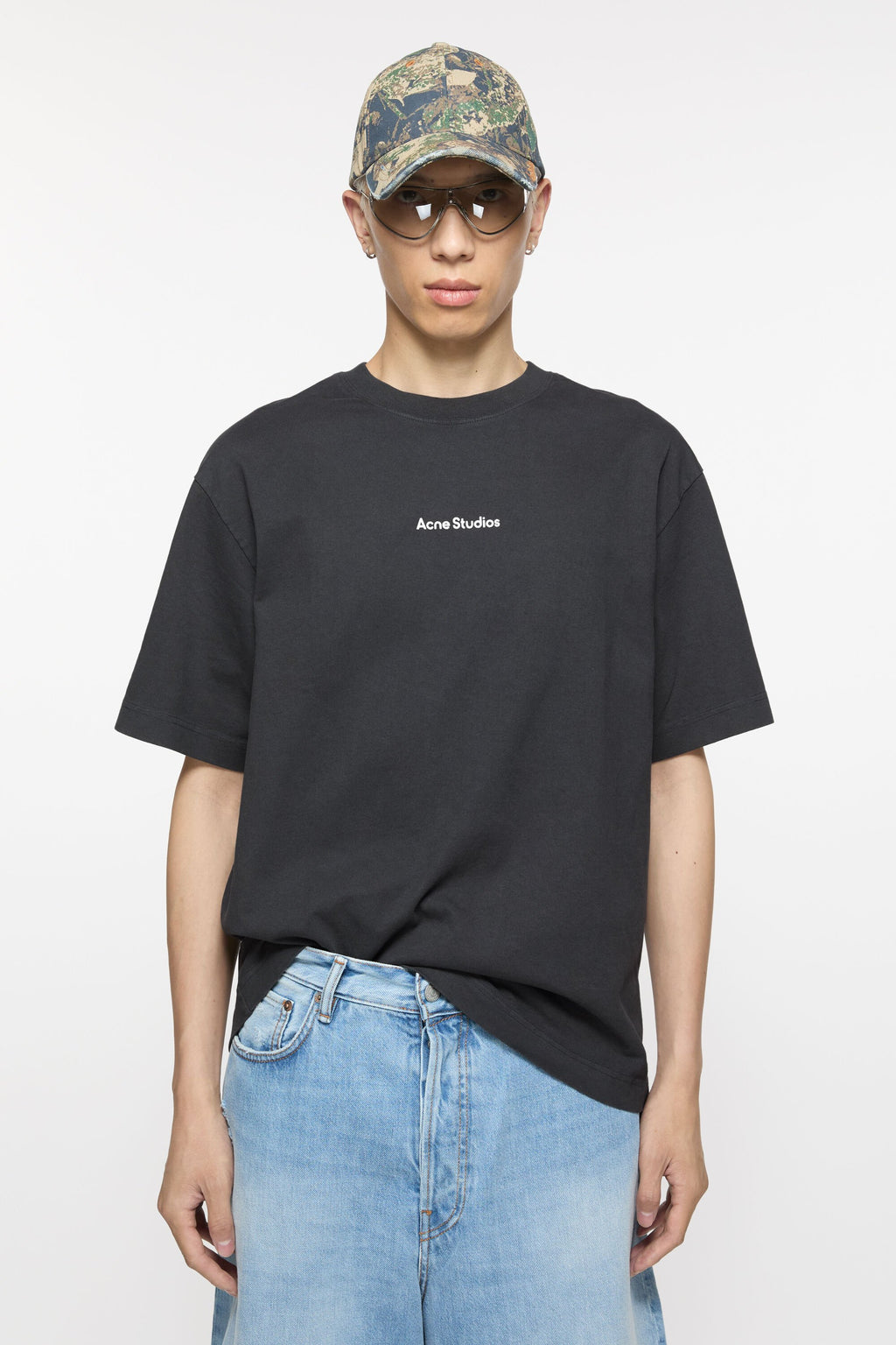 Black T-shirt worn by a person, showing the shirt’s fit