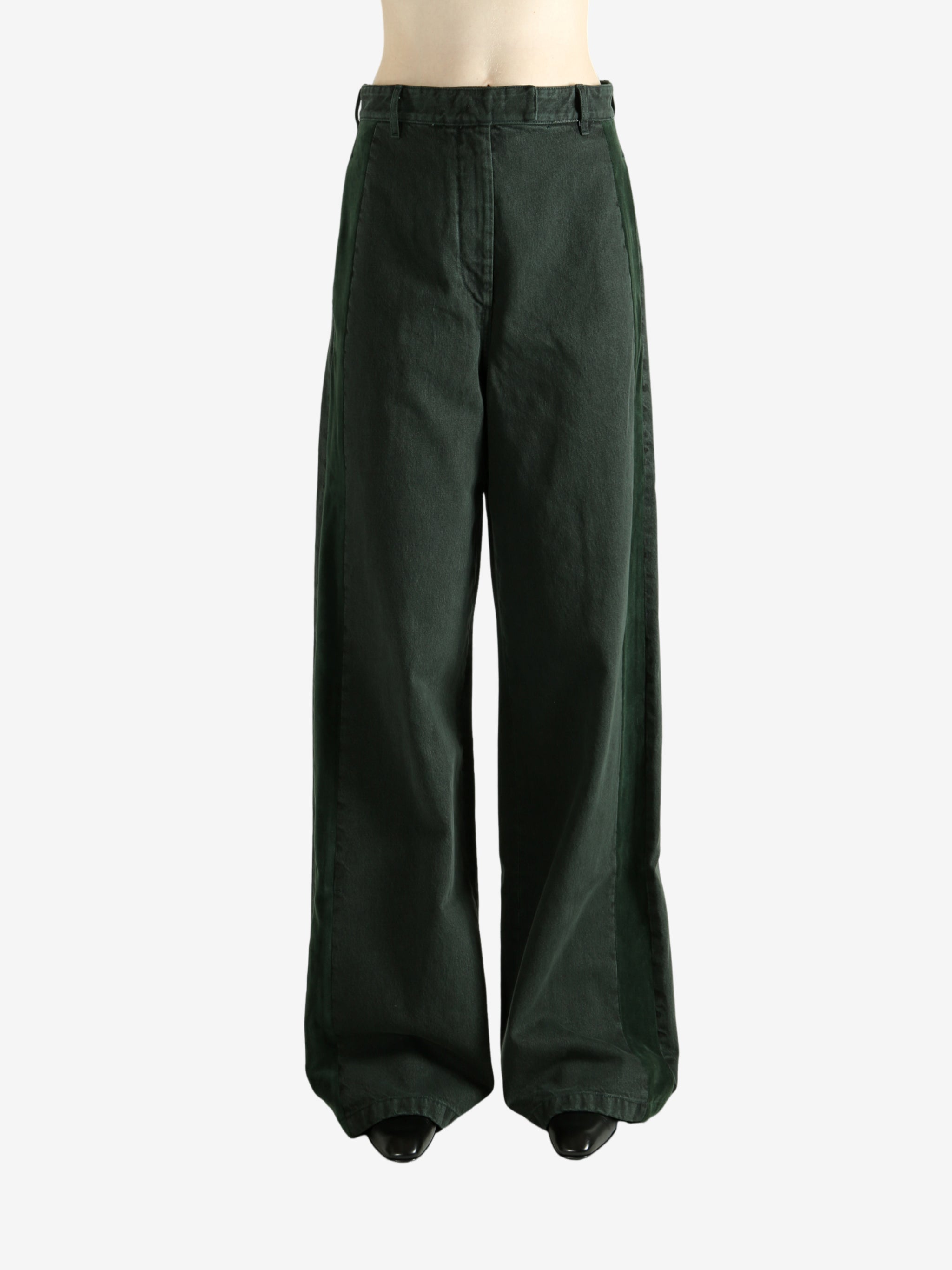 Green pants worn by a person, showing the pants's fit