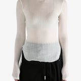 White top worn by a person, showing the top's fit