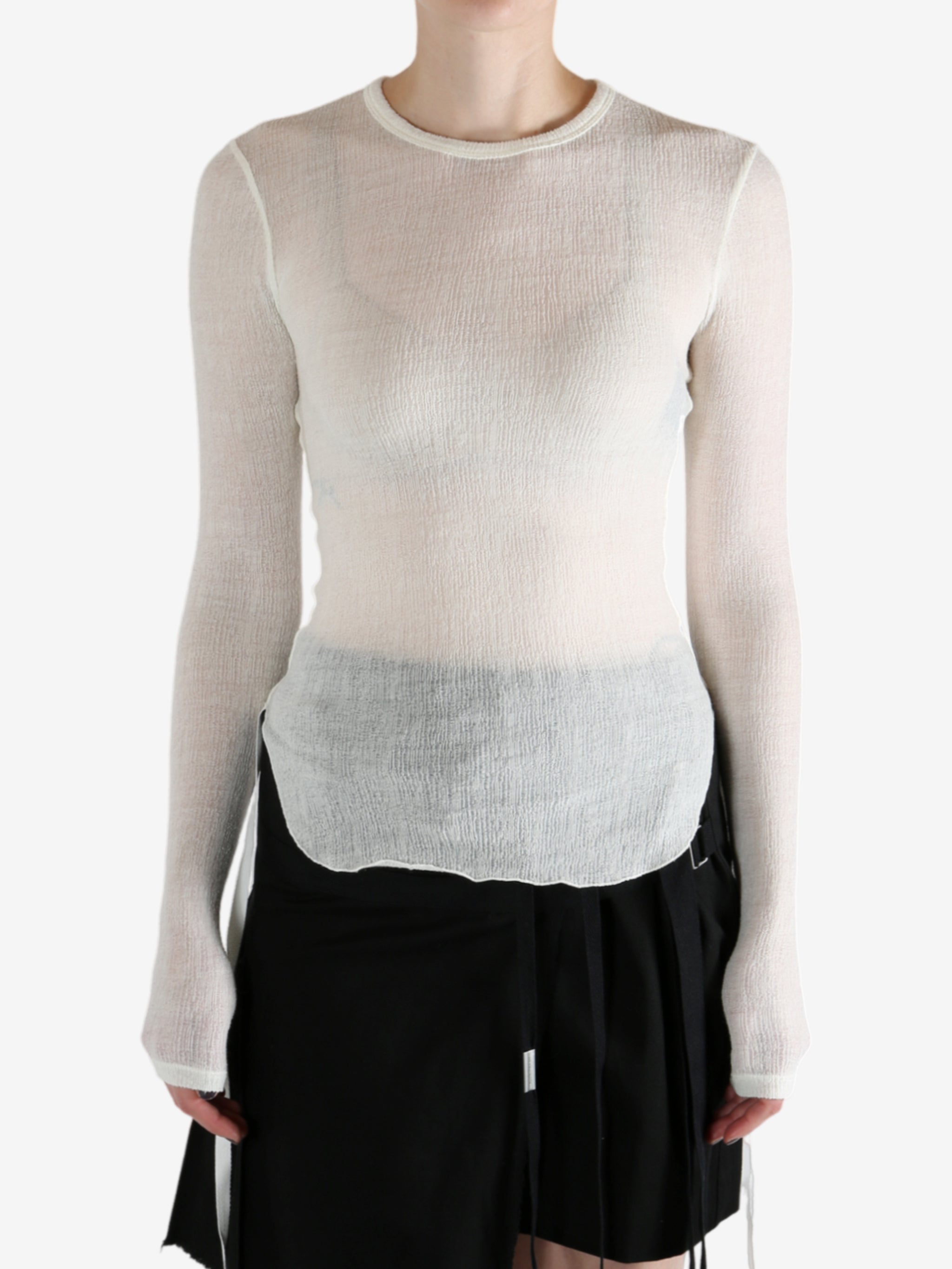 White top worn by a person, showing the top's fit