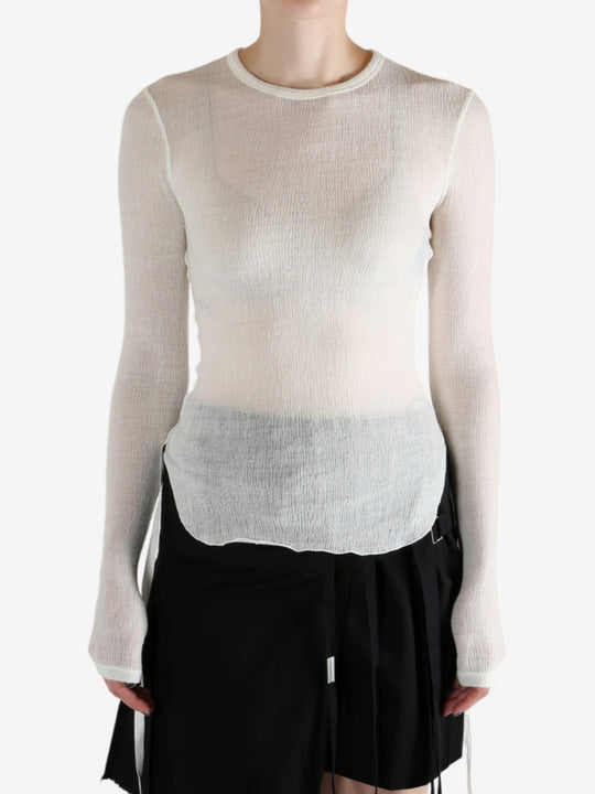 White top worn by a person, showing the top's fit