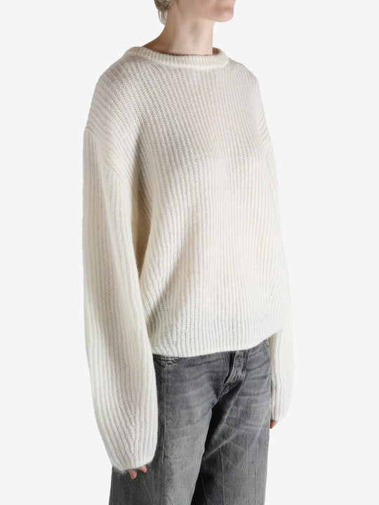 beige sweater worn by a person, showing the sweater fit