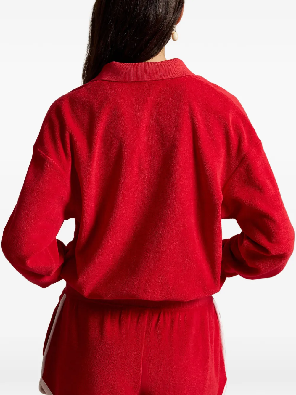Red knitwear worn by a person, showing the knitwear fit