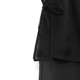 Close up of black pants, showing texture of the silk fabric