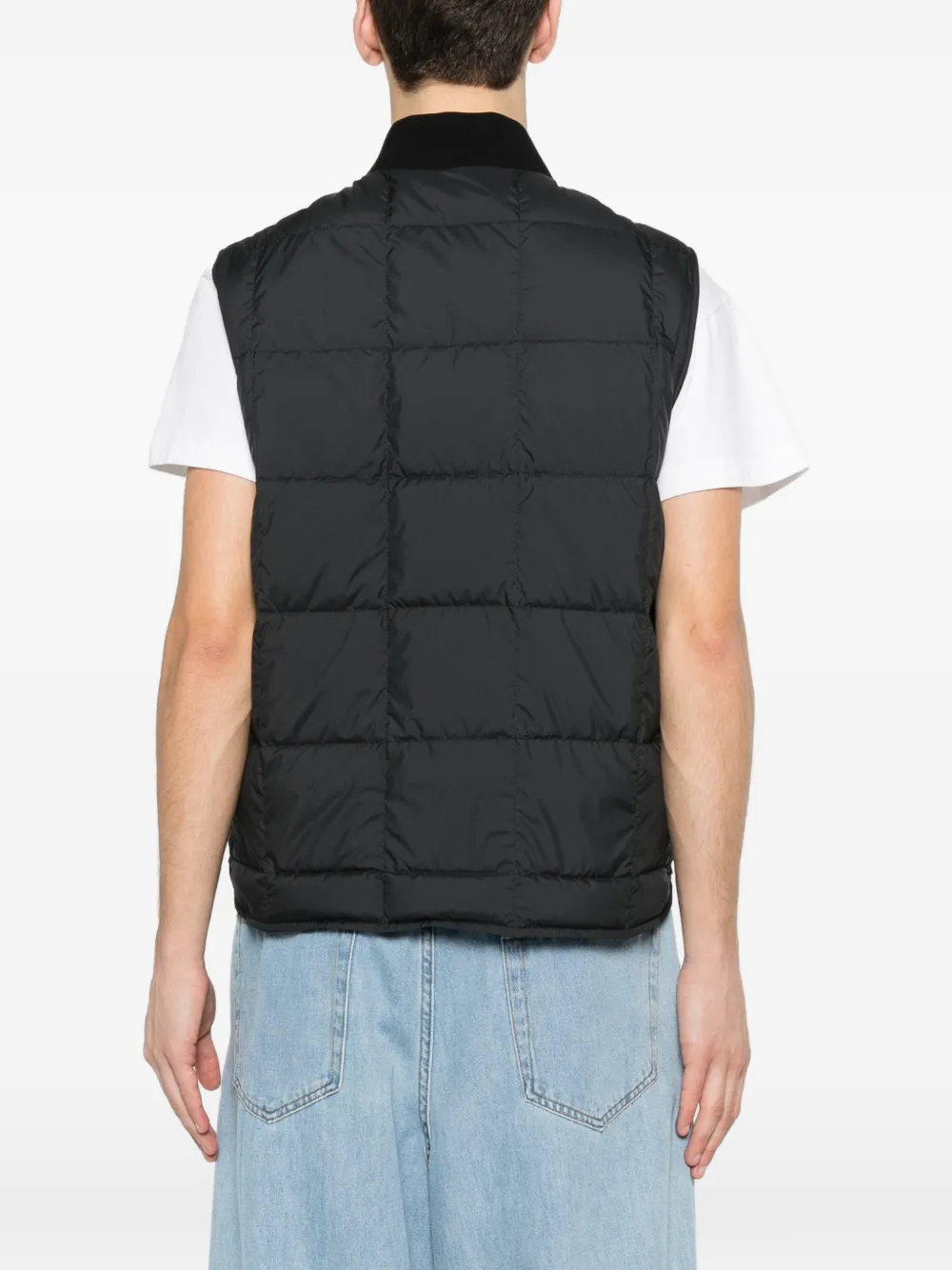 Black jackets-coats worn by a person, showing the jackets-coats's fit