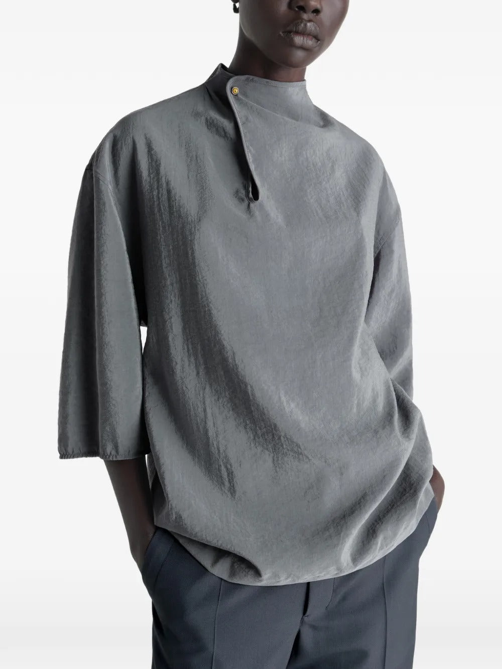 Grey top worn by a person, showing the top's fit