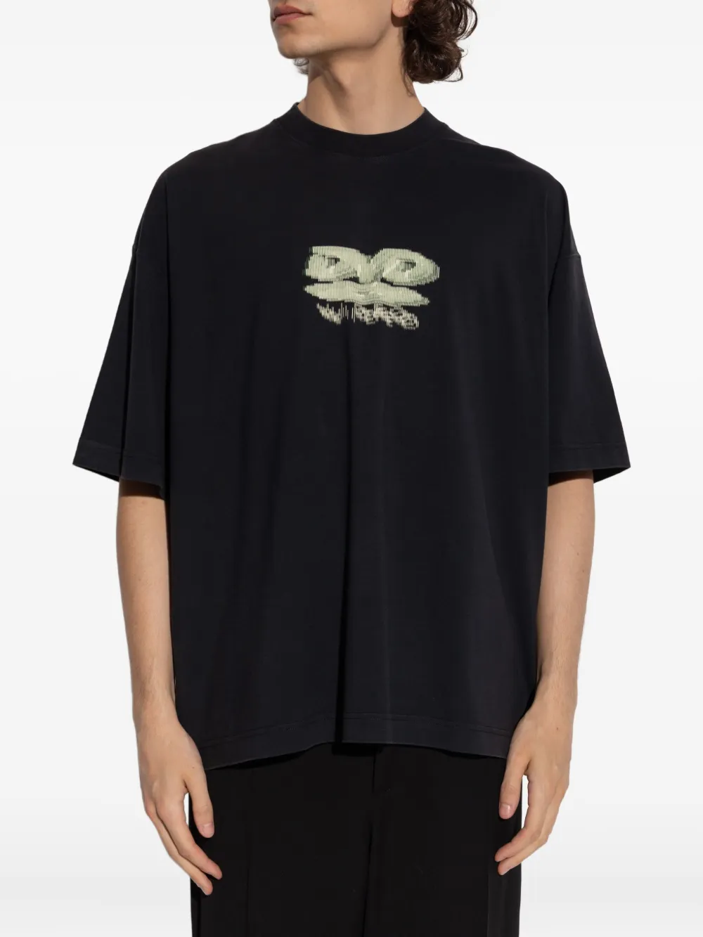 Black t-shirt worn by a person, showing the shirt's fit