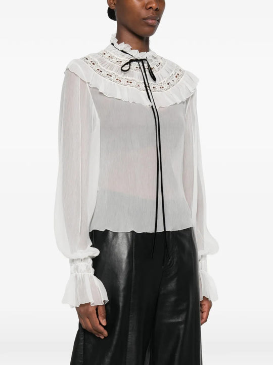 White top worn by a person, showing the top fit