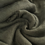 Close up of green scarf, showing texture of the cashmere fabric
