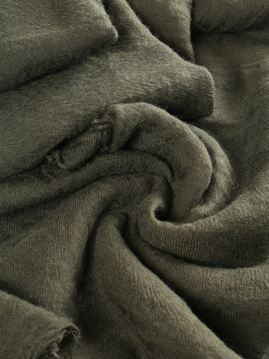 Close up of green scarf, showing texture of the cashmere fabric