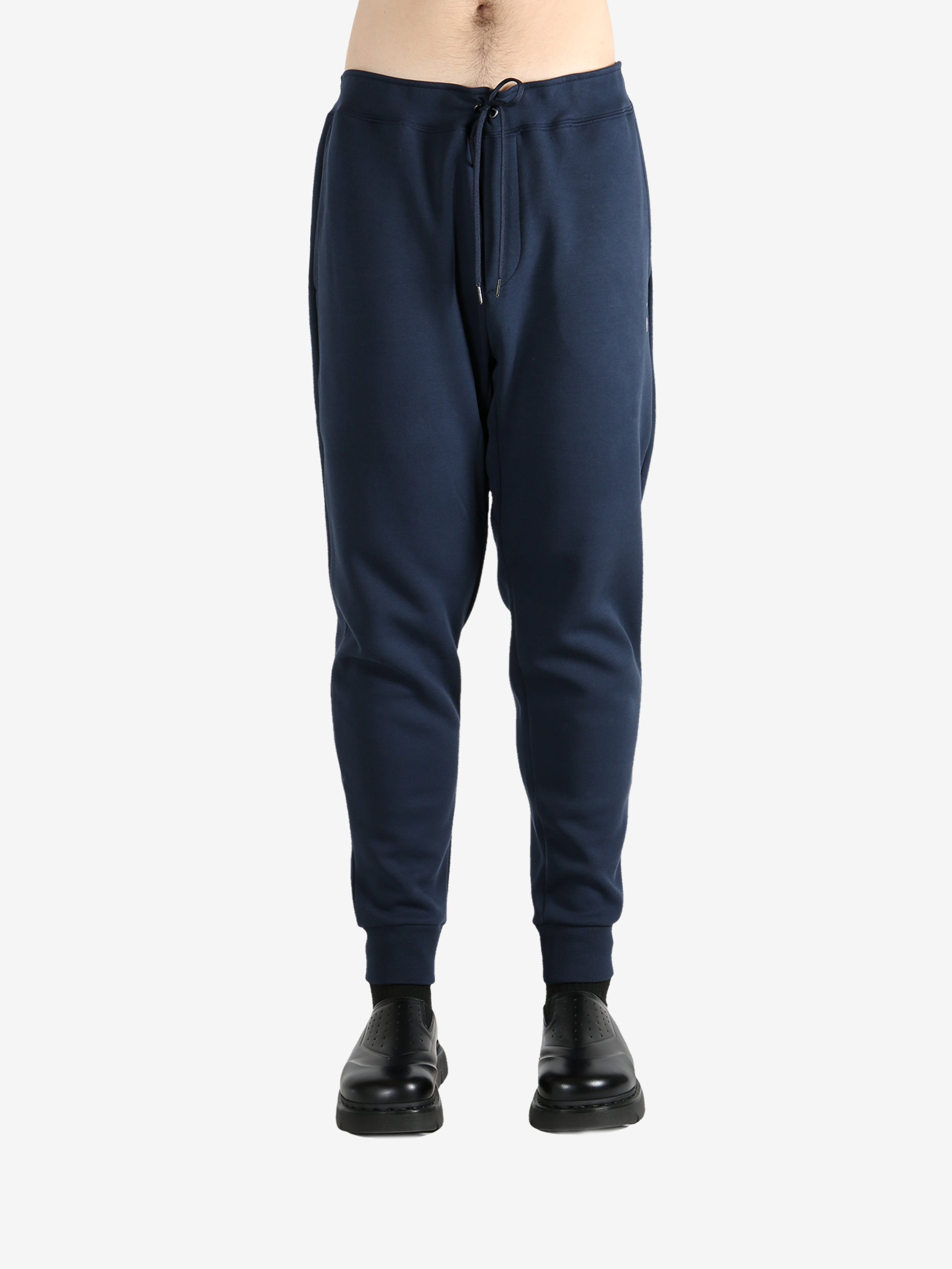 Navy pants worn by a person, showing the pants fit