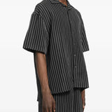 Black shirt worn by a person, showing the shirt's fit