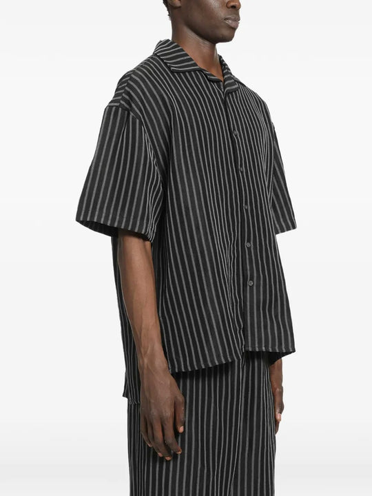 Black shirt worn by a person, showing the shirt's fit