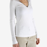 White tops worn by a person, showing the tops fit