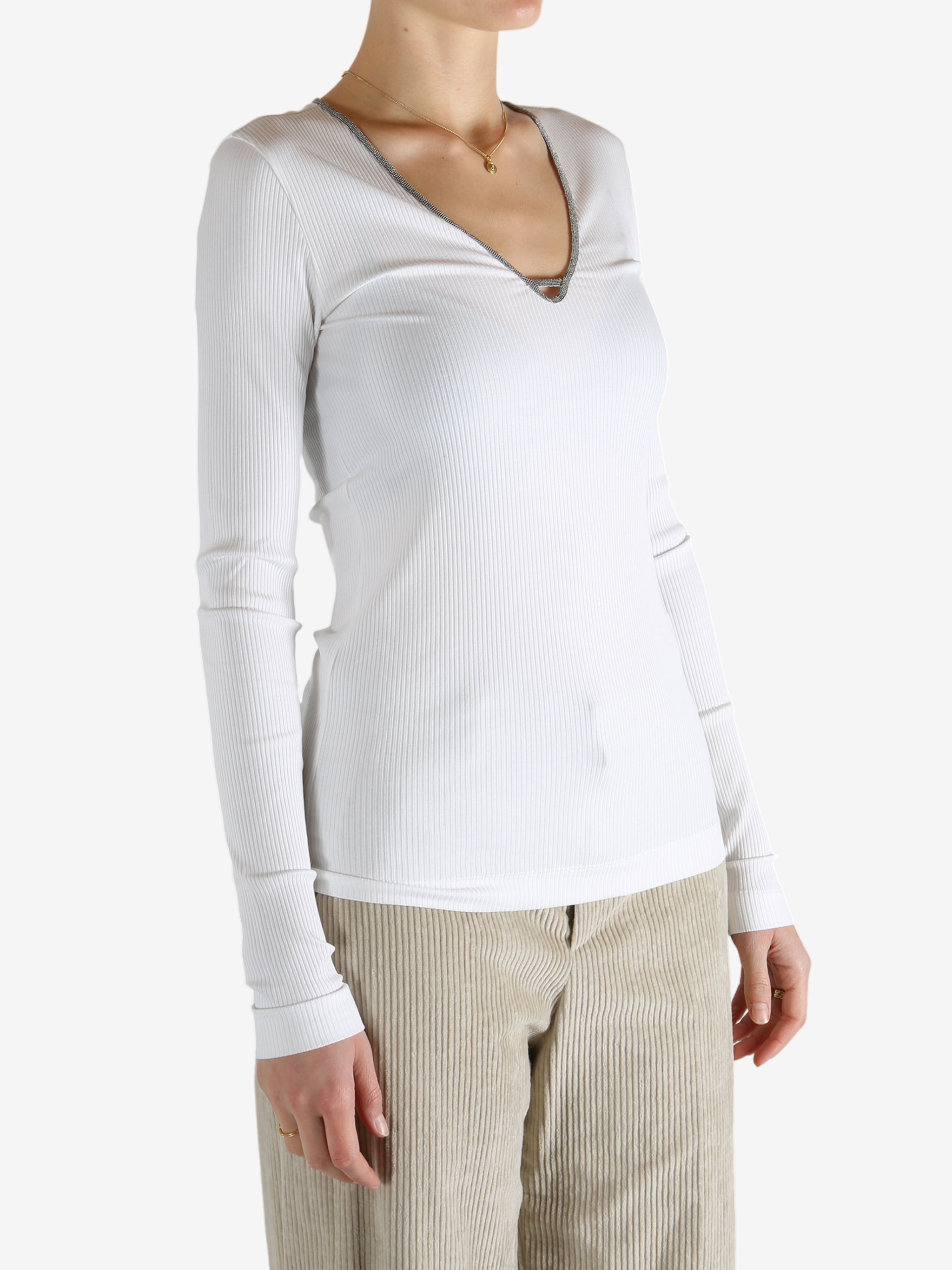 White tops worn by a person, showing the tops fit