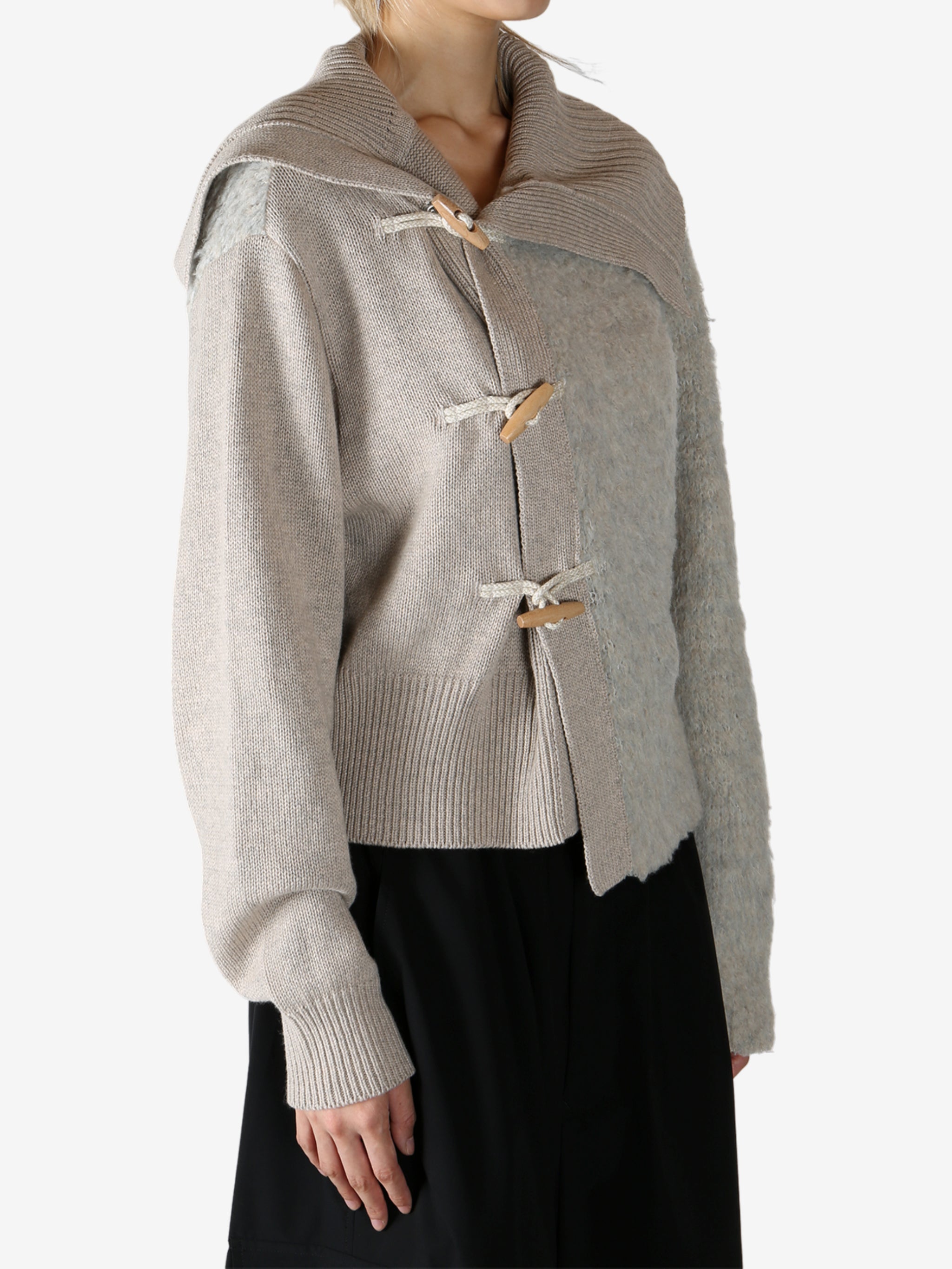 Tan knitwear worn by a person, showing the knitwear fit