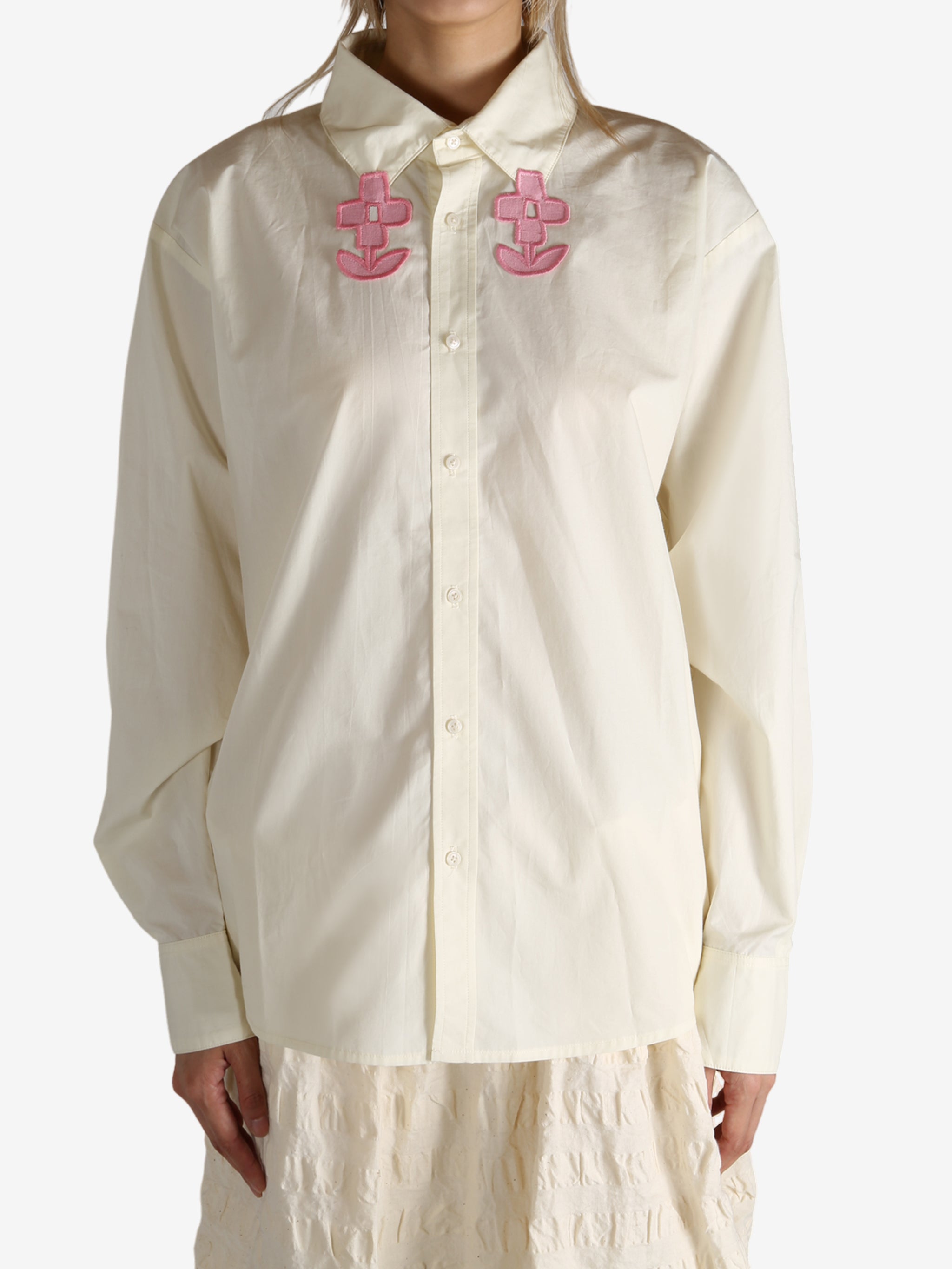 White shirt worn by a person, showing the shirt's fit