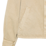 Close up of tan jacket, showing texture of the cotton fabric