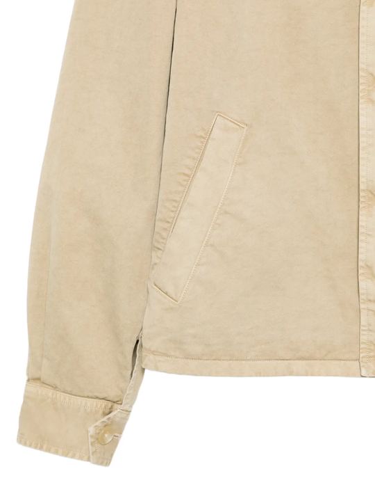 Close up of tan jacket, showing texture of the cotton fabric