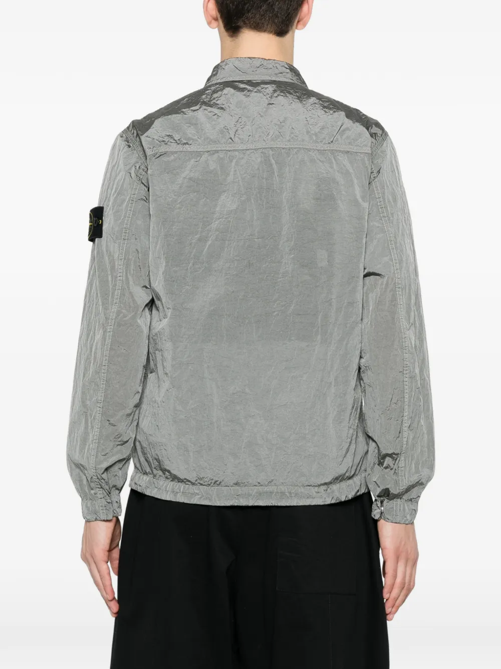 Grey coat worn by a person, showing the coat's fit