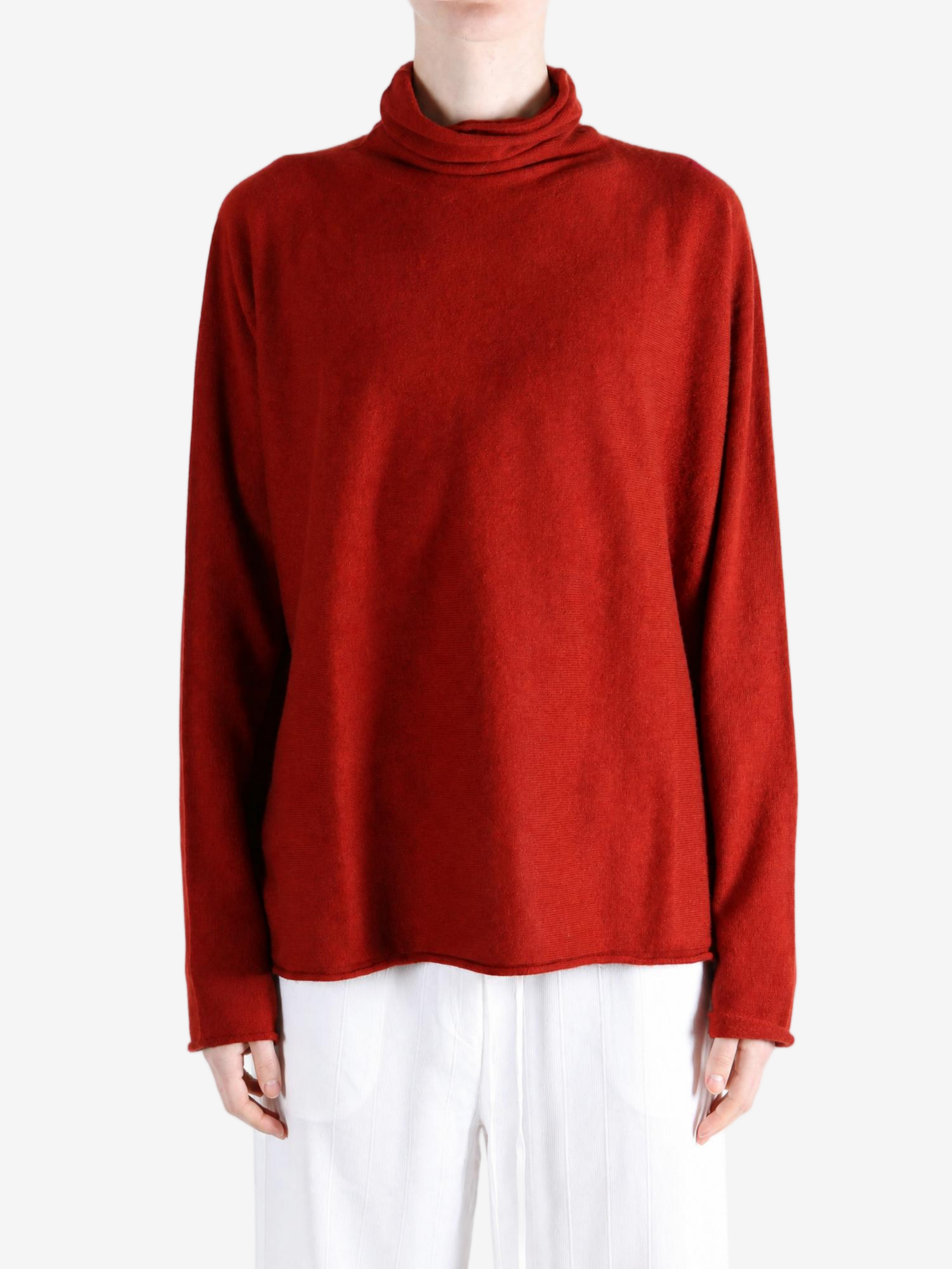 Red knitwear worn by a person, showing the knitwear fit