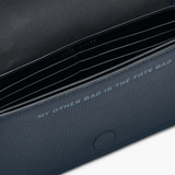 Close up of the navy bag, showing texture of the leather fabric