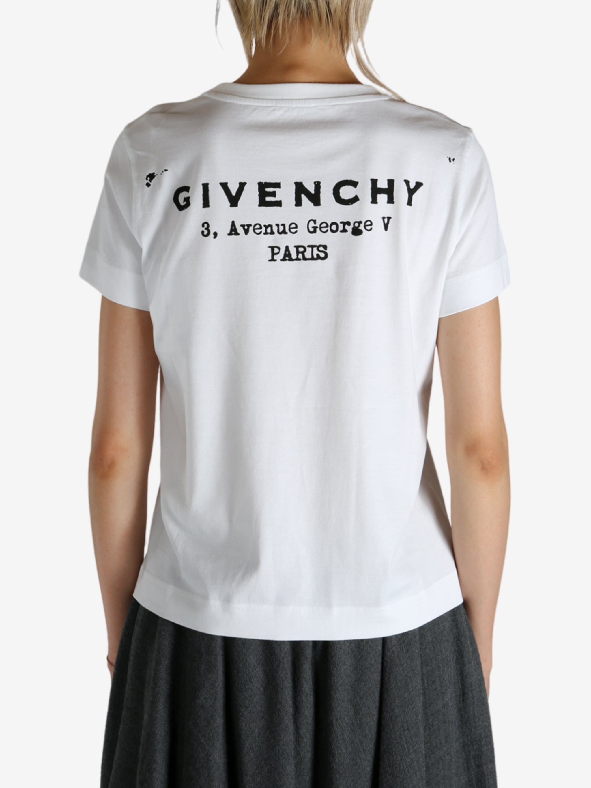 White t-shirt worn by a person, showing the shirt's fit