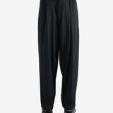 Black pants worn by a person, showing the pants' fit