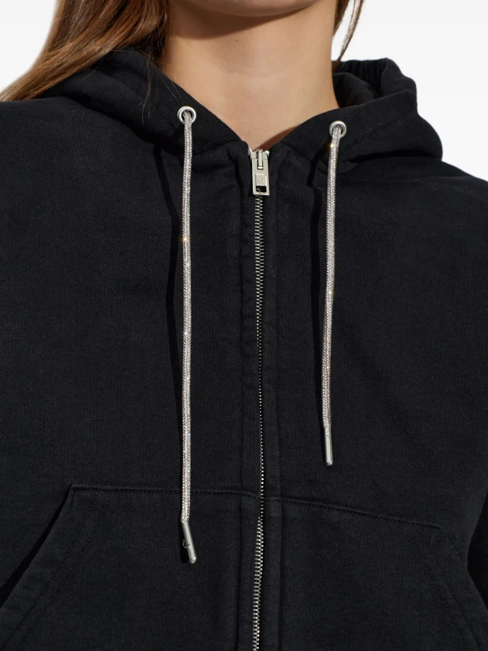 Close up of black hoodie, showing texture of the cotton fabric