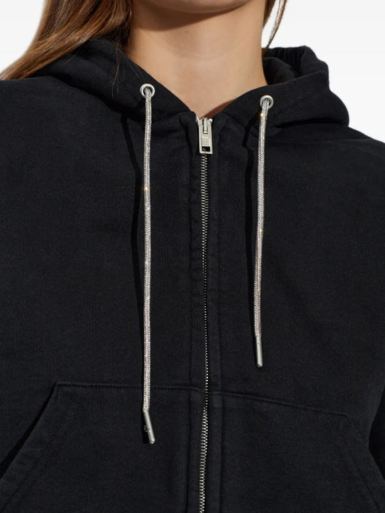 Close up of black hoodie, showing texture of the cotton fabric