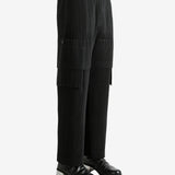 Black pants worn by a person, showing the pant's fit